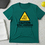 Caution still learning, stay clear of the kitchen T-Shirt